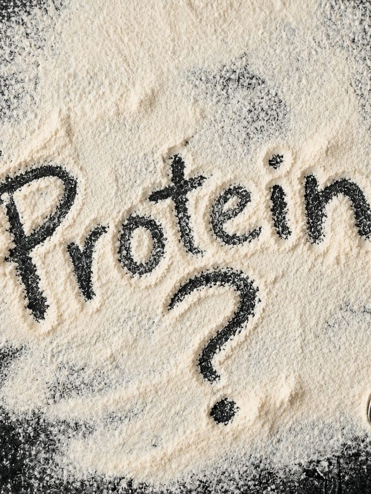 The word "Protein" and a question mark written into spilled flour